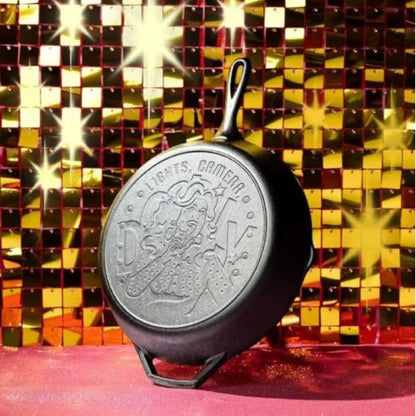 Cast iron skillet with a logo on a disco ball background