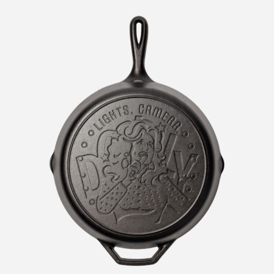 Black cast iron skillet with embossed design on a white background