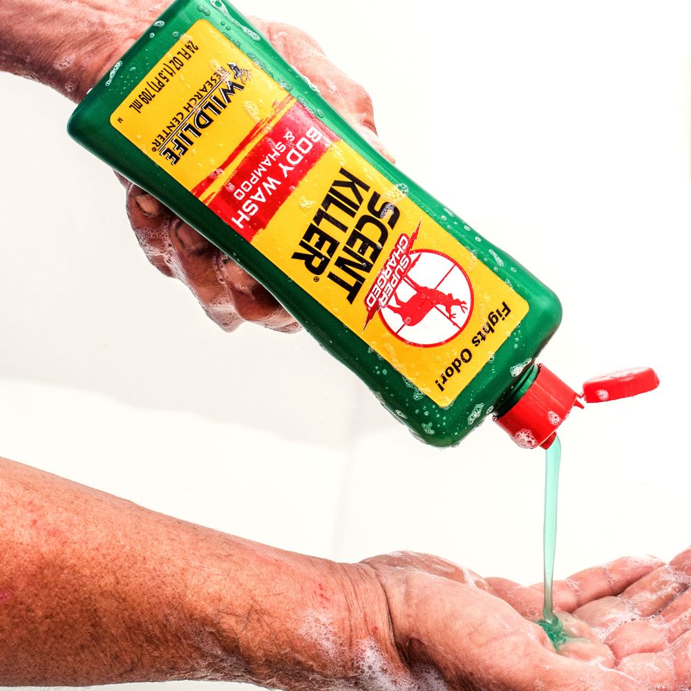 Hand holding a bottle of 'Finger Killer' soap with a white background