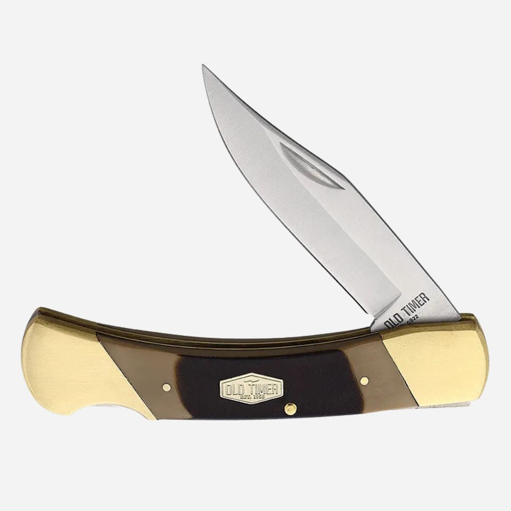 Folding knife with gold and black handle on a white background