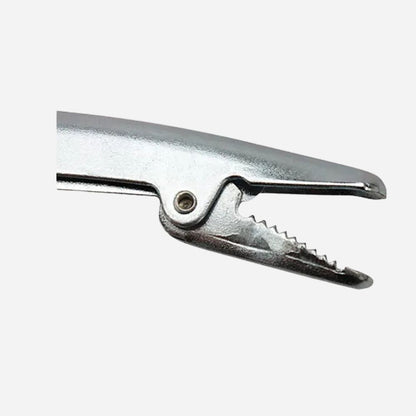 A close-up of a metallic silver spring clamp or anvil tool against a plain light gray background.