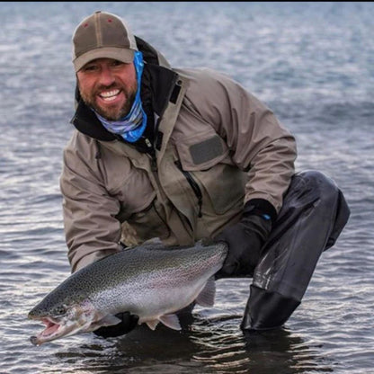 Man holding a large fish in a body of water