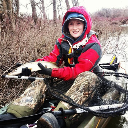 Person holding a large fish in a wintery outdoor setting