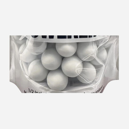 Clear plastic bag filled with white spherical objects on a white background