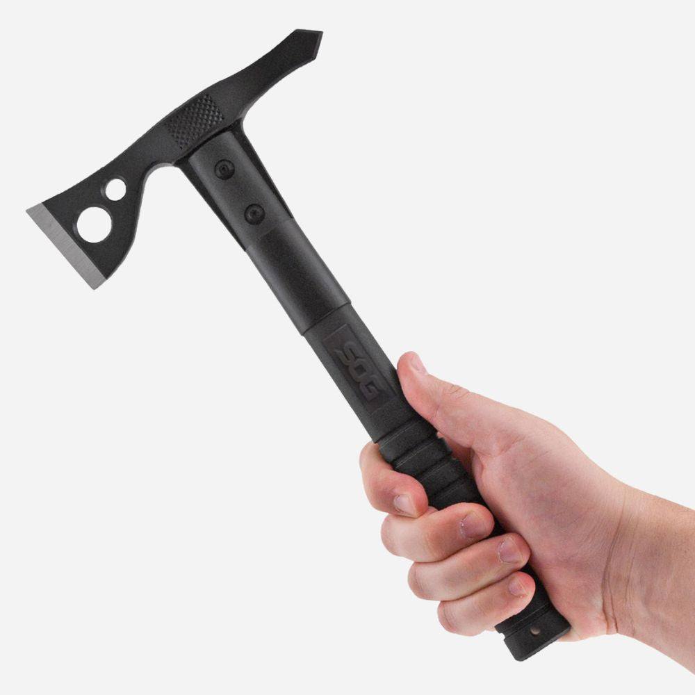 Black tomahawk held in a hand against a white background