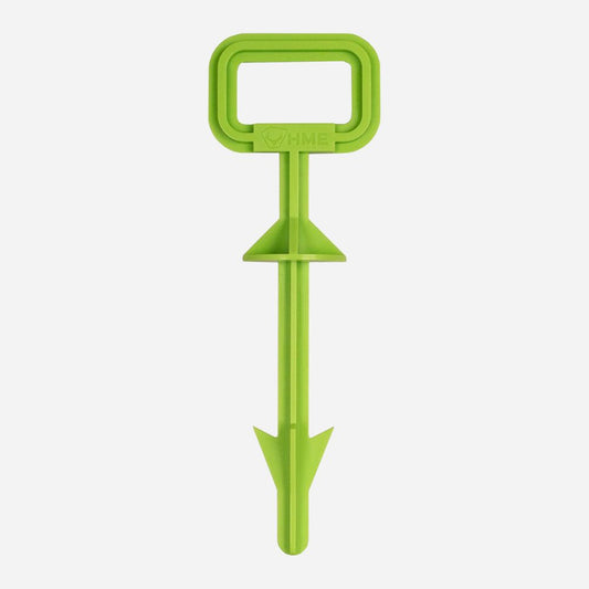 Green plastic tool with a handle on a white background