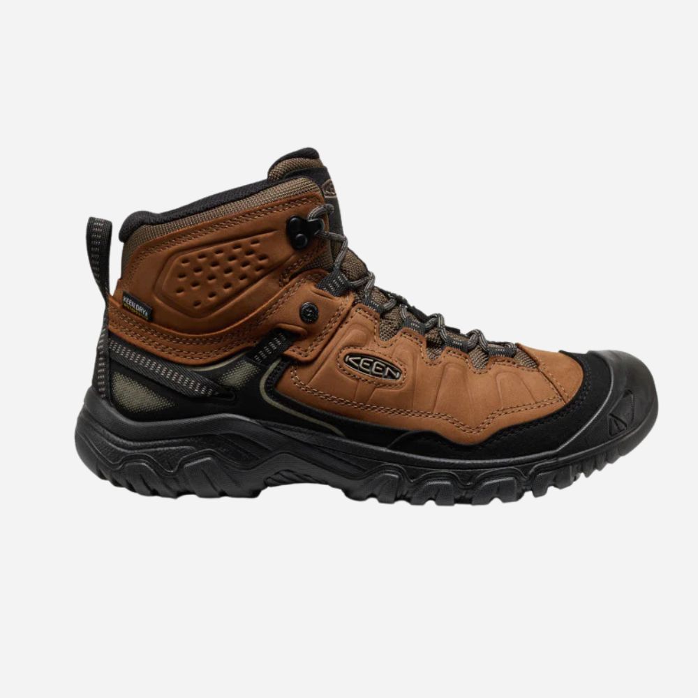 Brown hiking boot with black sole on a white background