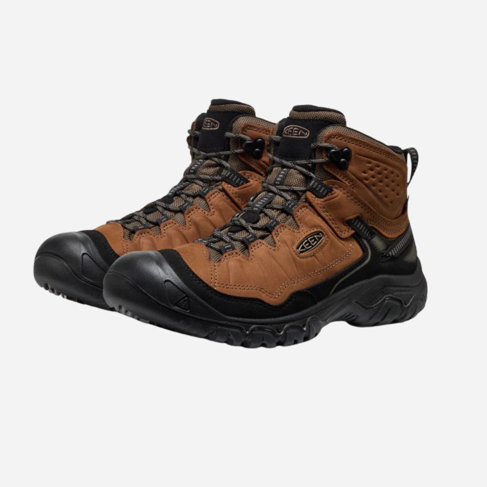 Pair of brown hiking boots with black soles on a white background