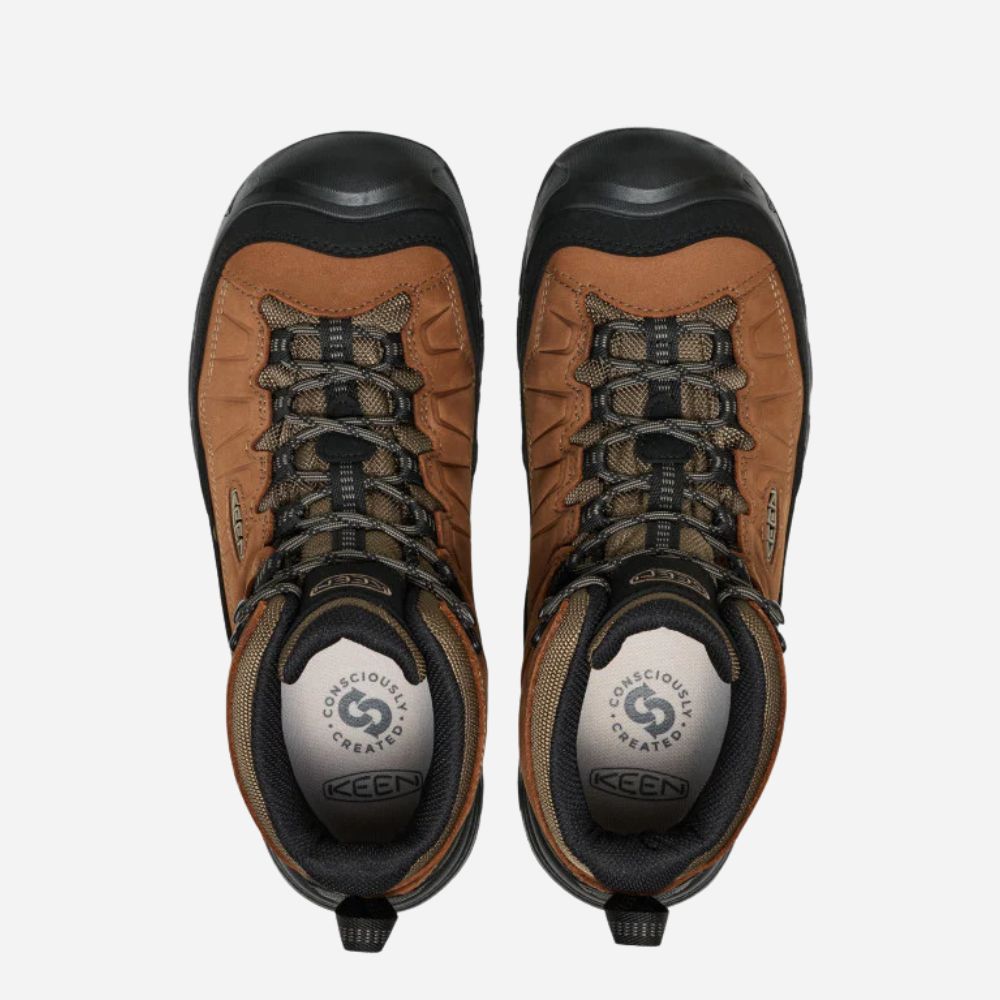 Pair of brown and black KEEN hiking boots on a white background