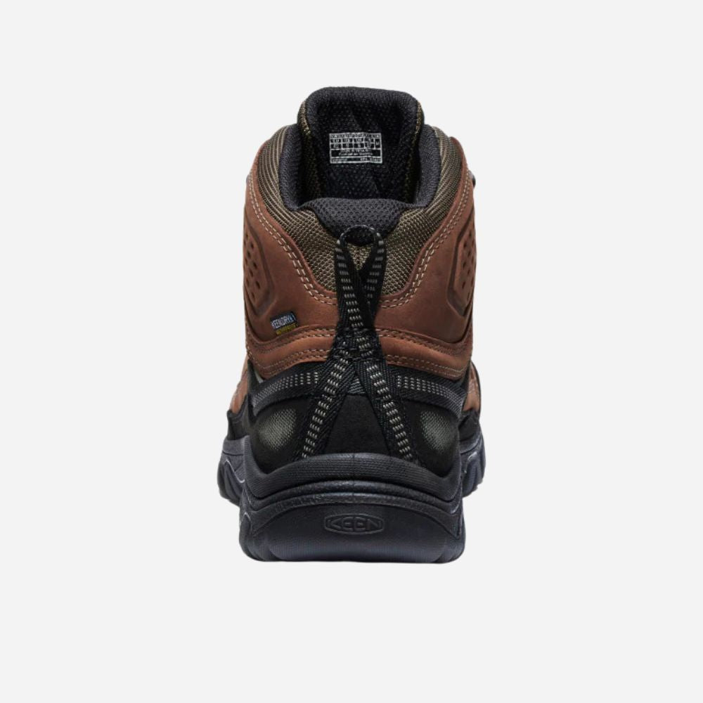 Brown and black hiking boot with a zipper on a white background