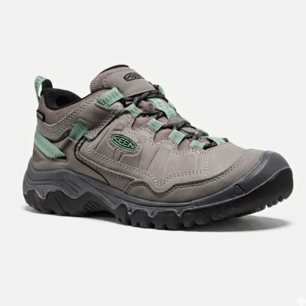 Gray hiking shoe with green accents on a white background