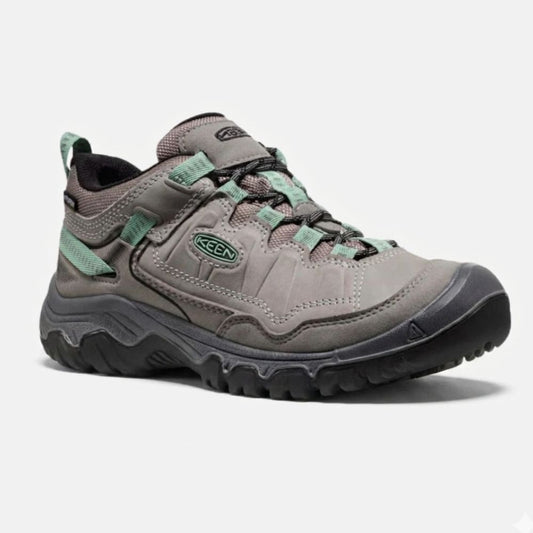 Gray hiking shoe with green accents on a white background