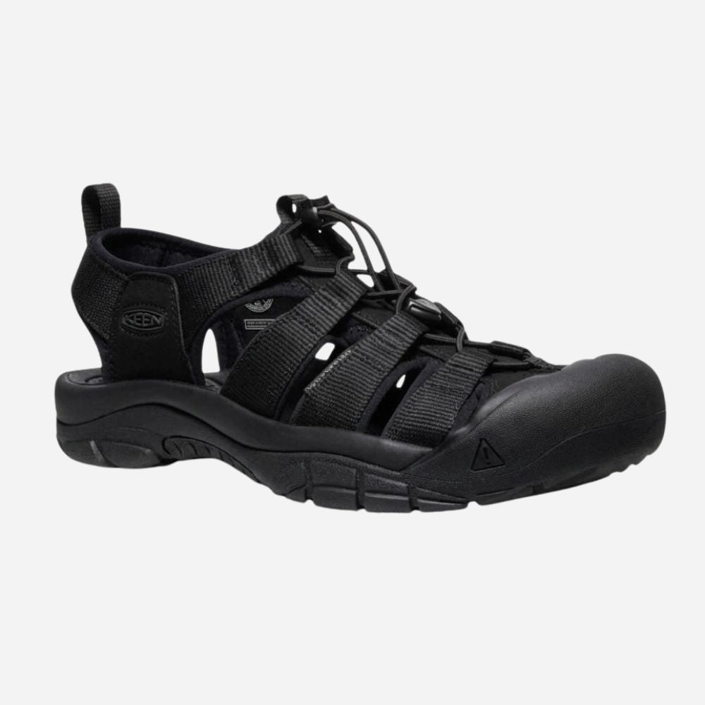 Black shoe with a strap on a light gray background