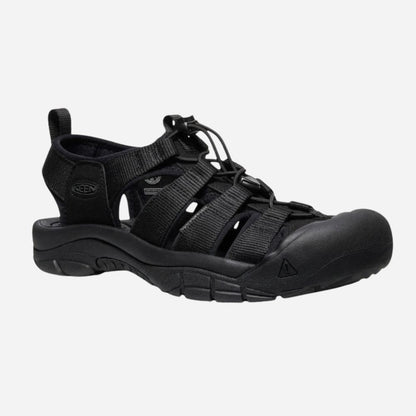 Black shoe with a strap on a light gray background