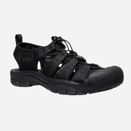 Black shoe with a strap on a light gray background