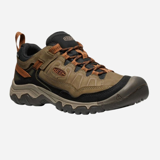 Brown hiking shoe with orange accents on a white background