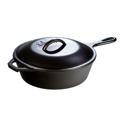 Black cast iron skillet with lid on a white background