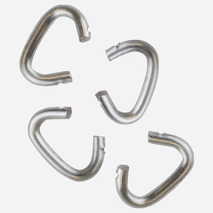 Four metallic curtain hooks on a white background