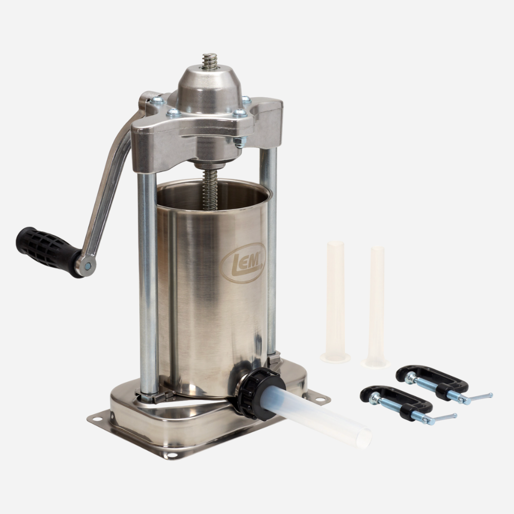 Stainless steel manual meat grinder with attachments on a white background