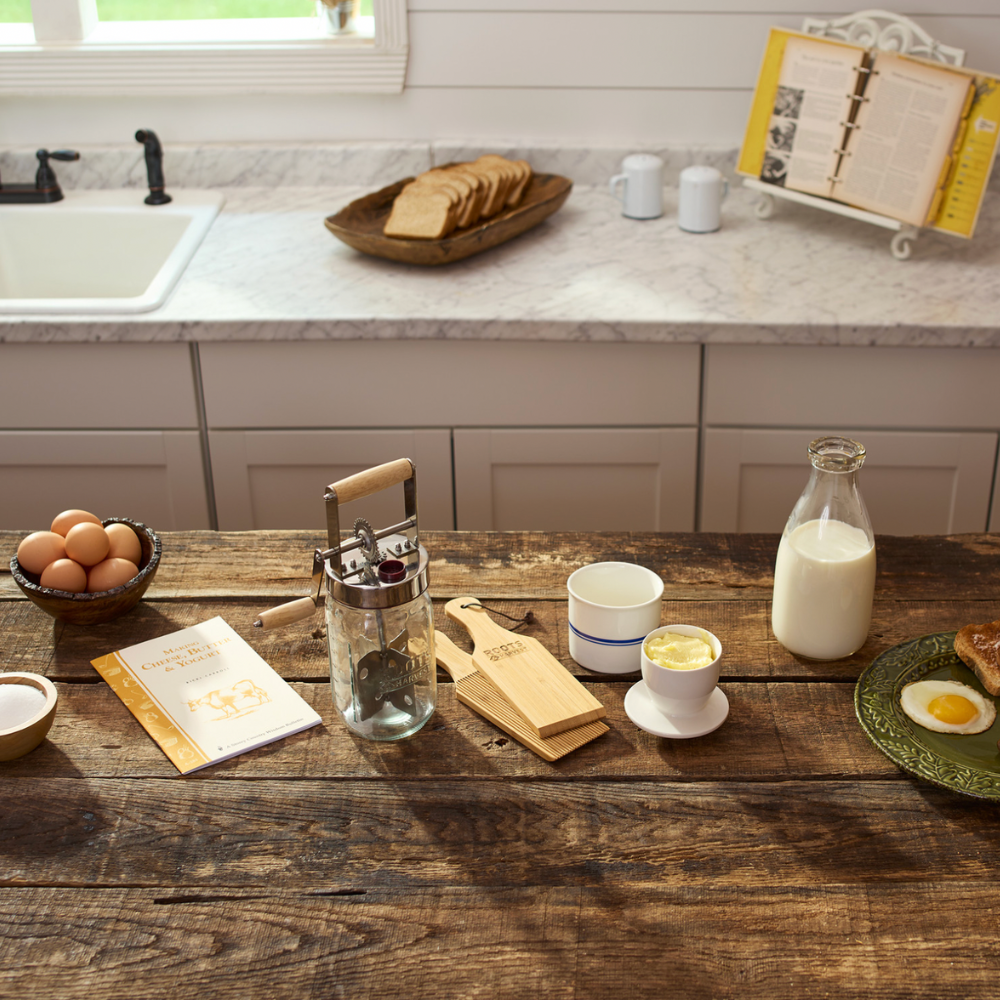 Kitchen counter with various items including a bowl of eggs, a bottle of milk, and a plate with a sandwich and egg.