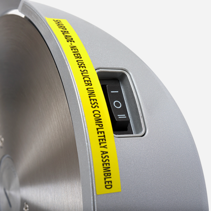 Saw blade with a yellow warning label on a gray background