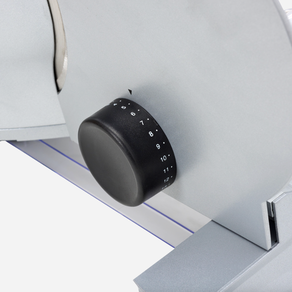 Black knob on a white appliance with numbers