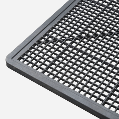 Black plastic grid mat on a white background