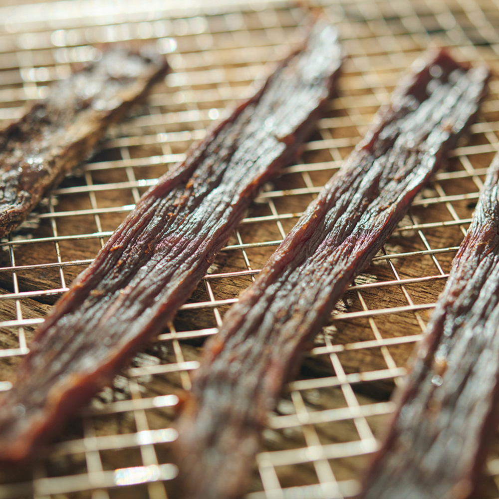 Dried meat strips on a wire rack