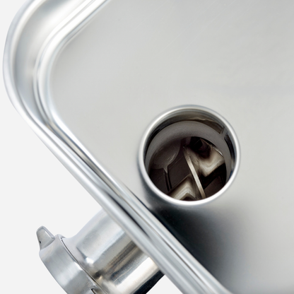 Close-up of a metallic object with a central circular component on a white background