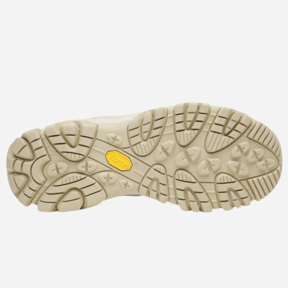 The outsole of a hiking boot shown from a top-down view, featuring a beige textured tread pattern with a small yellow Vibram logo in the center.