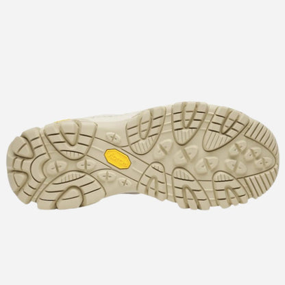 The outsole of a hiking boot shown from a top-down view, featuring a beige textured tread pattern with a small yellow Vibram logo in the center.