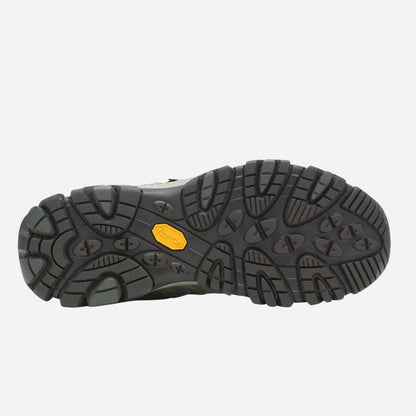 Close-up of a black shoe sole with a yellow label on a white background