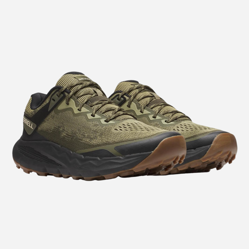 Green hiking shoes with brown soles on a white background