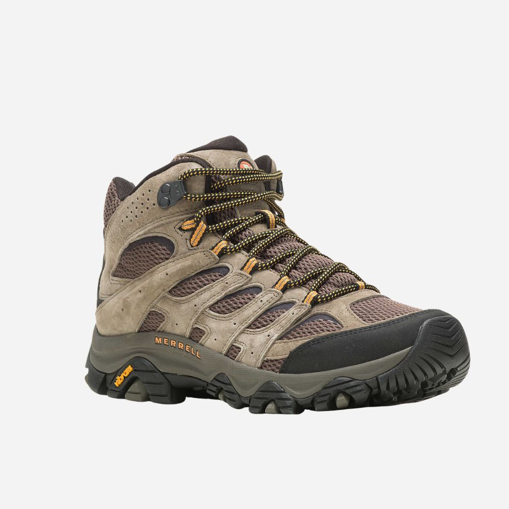 Brown hiking boot with black sole on a white background