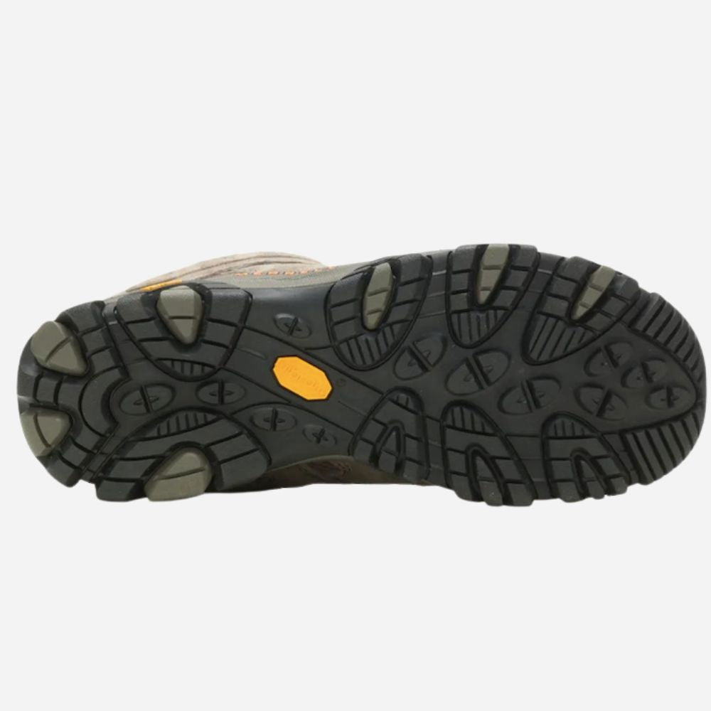 The outsole of a hiking boot, showing a black Vibram tread pattern with a small yellow Vibram logo and gray rubber accents, photographed on a light gray background.