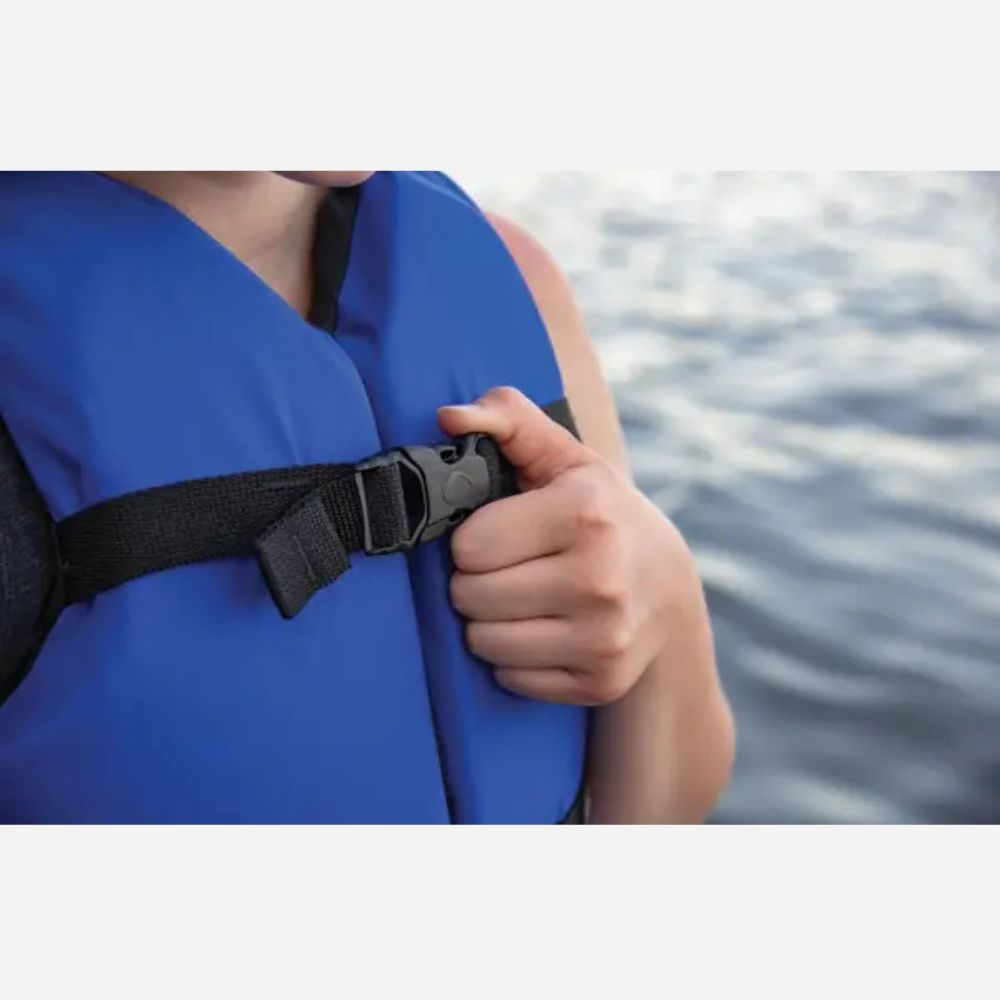 Person wearing a blue life jacket with a blurred water background