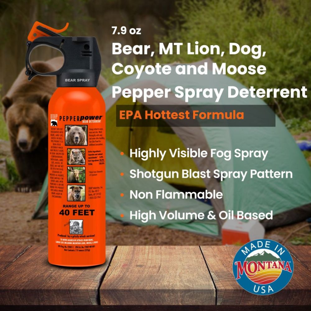 Orange pepper spray canister with bear, mountain lion, dog, coyote, and moose images on a wooden surface with a tent and bear in the background.