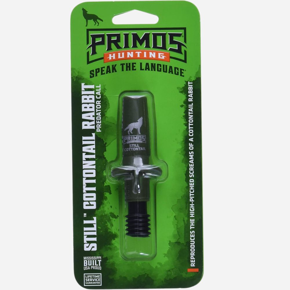 Primos Hunting Still Cottontail Rabbit Predator Call in its original green blister card packaging, featuring a black and silver metal call with a wolf logo.