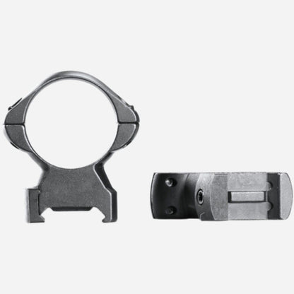 Two metallic rifle scope rings on a white background