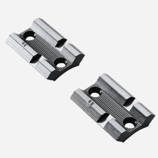 Two metallic slide components on a white background