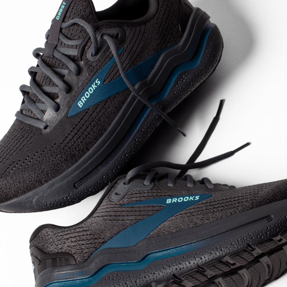 Black and blue running shoes with 'Brooks' branding on a white background
