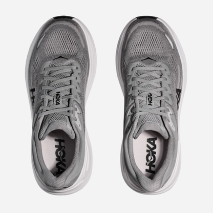 Pair of gray running shoes with 'Hoka' branding on a white background