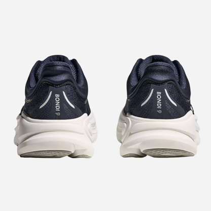 Navy running shoes with white soles on a light gray background