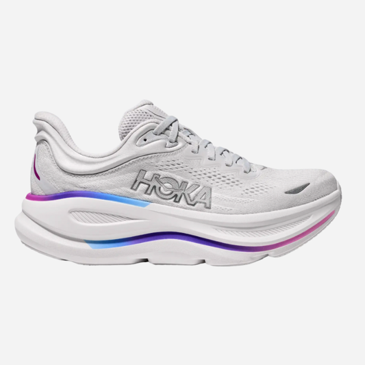 White running shoe with colorful sole on a white background
