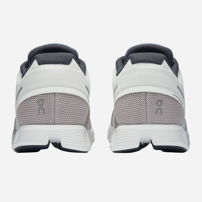 White and gray athletic shoes with a visible brand logo on a white background